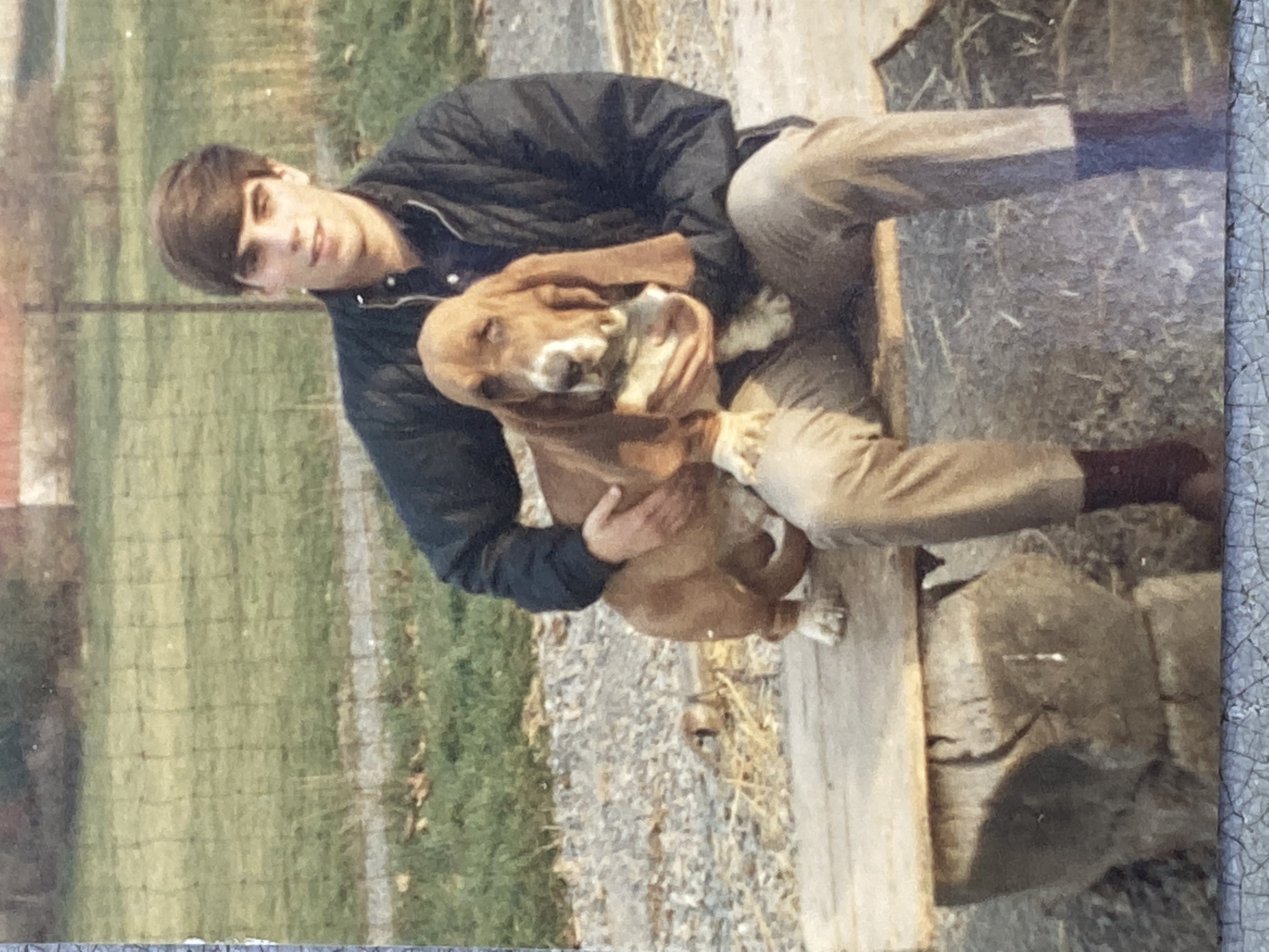 Young John Tait with a Basset Hound on the farm